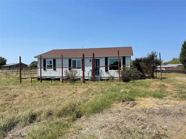 a view of a house with garden and sitting area
