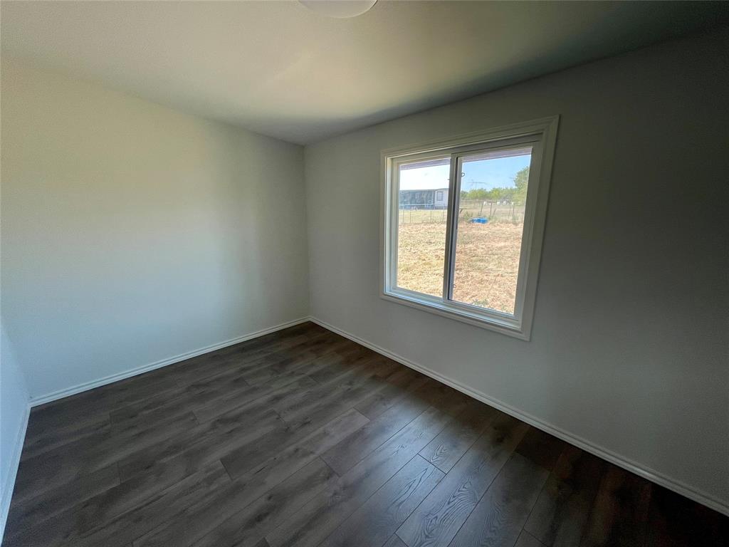 7976 Bearhill Road Royse City, TX 75189 - Photo 13 of 27 an empty room with wooden floor and windows