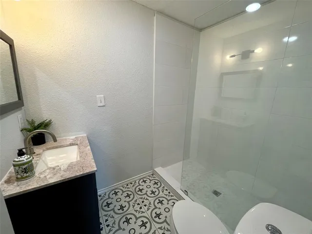 a bathroom with a sink toilet and shower