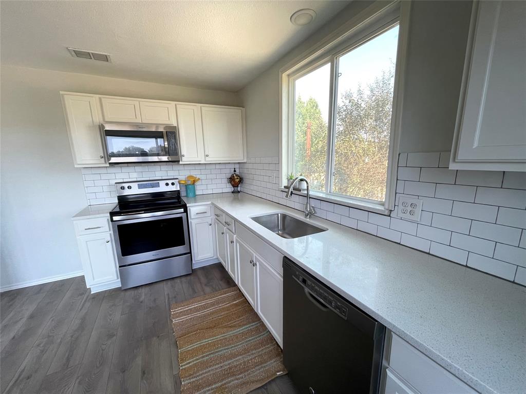 7976 Bearhill Road Royse City, TX 75189 - Photo 4 of 27 a kitchen with a stove a sink and a window