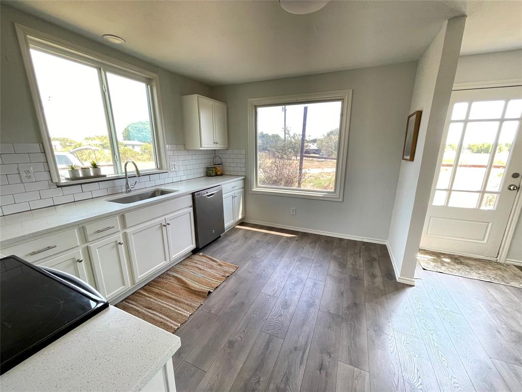 7976 Bearhill Road Royse City, TX 75189 - Photo 5 of 27 a large kitchen with stainless steel appliances a large window a sink and cabinets