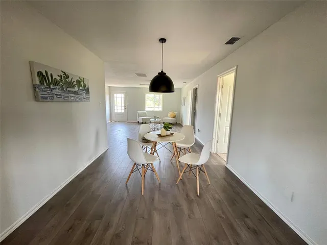 a dining room with furniture window and wooden floor