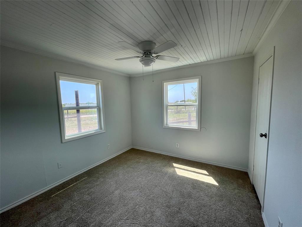 7976 Bearhill Road Royse City, TX 75189 - Photo 9 of 27 an empty room with windows and fan