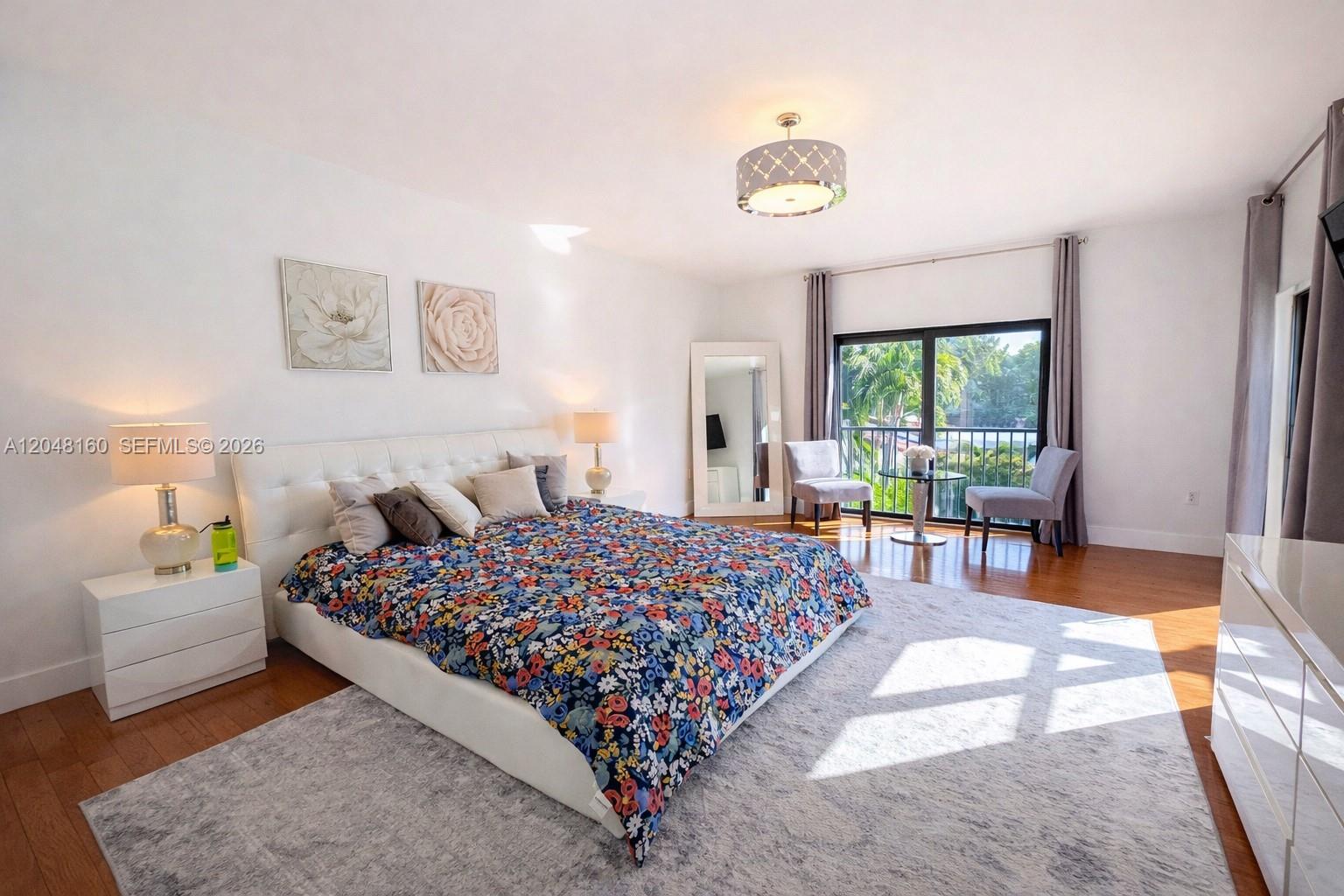 471 Southwest 30th Road Miami, FL 33129 - Photo 26 of 39 large primary bedroom suite with sitting area, large ensuite bathroom, floor to ceiling window, glass door to second floor terrace, walk-in closet and additional built-in closets.