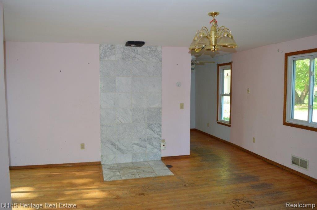2450 East Coon Lake Road Howell, MI 48843 - Photo 27 of 49 Dining room with area where wood stove had been