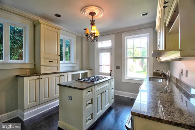 a kitchen with stainless steel appliances granite countertop a stove refrigerator and cabinets