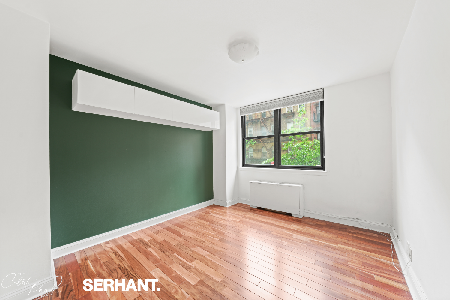 225 East 36th Street, Unit 2N Manhattan, NY 10016 - Photo 11 of 28 an empty room with wooden floor and windows