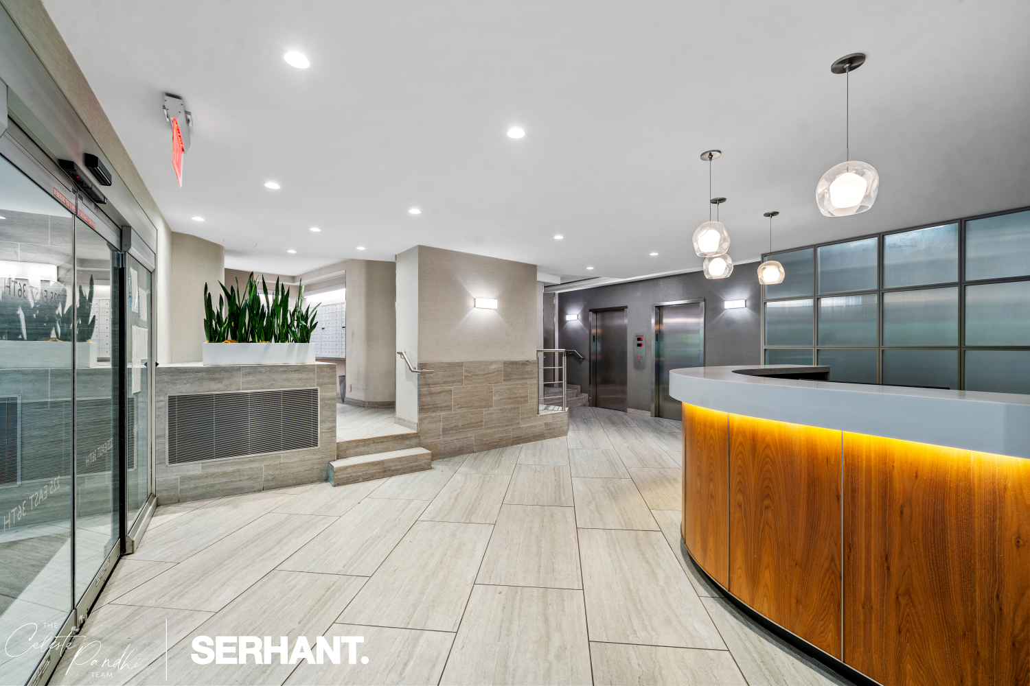 225 East 36th Street, Unit 2N Manhattan, NY 10016 - Photo 20 of 28 a large hall with stainless steel appliances kitchen island a large tub a sink and glass door