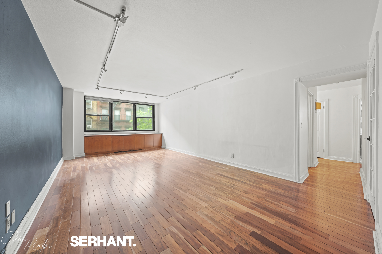 225 East 36th Street, Unit 2N Manhattan, NY 10016 - Photo 2 of 28 a view of an empty room with wooden floor and a window