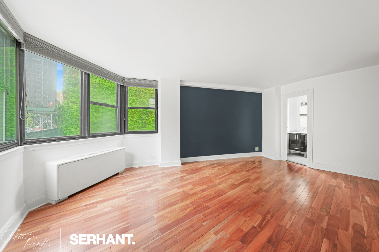 225 East 36th Street, Unit 2N Manhattan, NY 10016 - Photo 8 of 28 a view of an empty room with wooden floor and a window