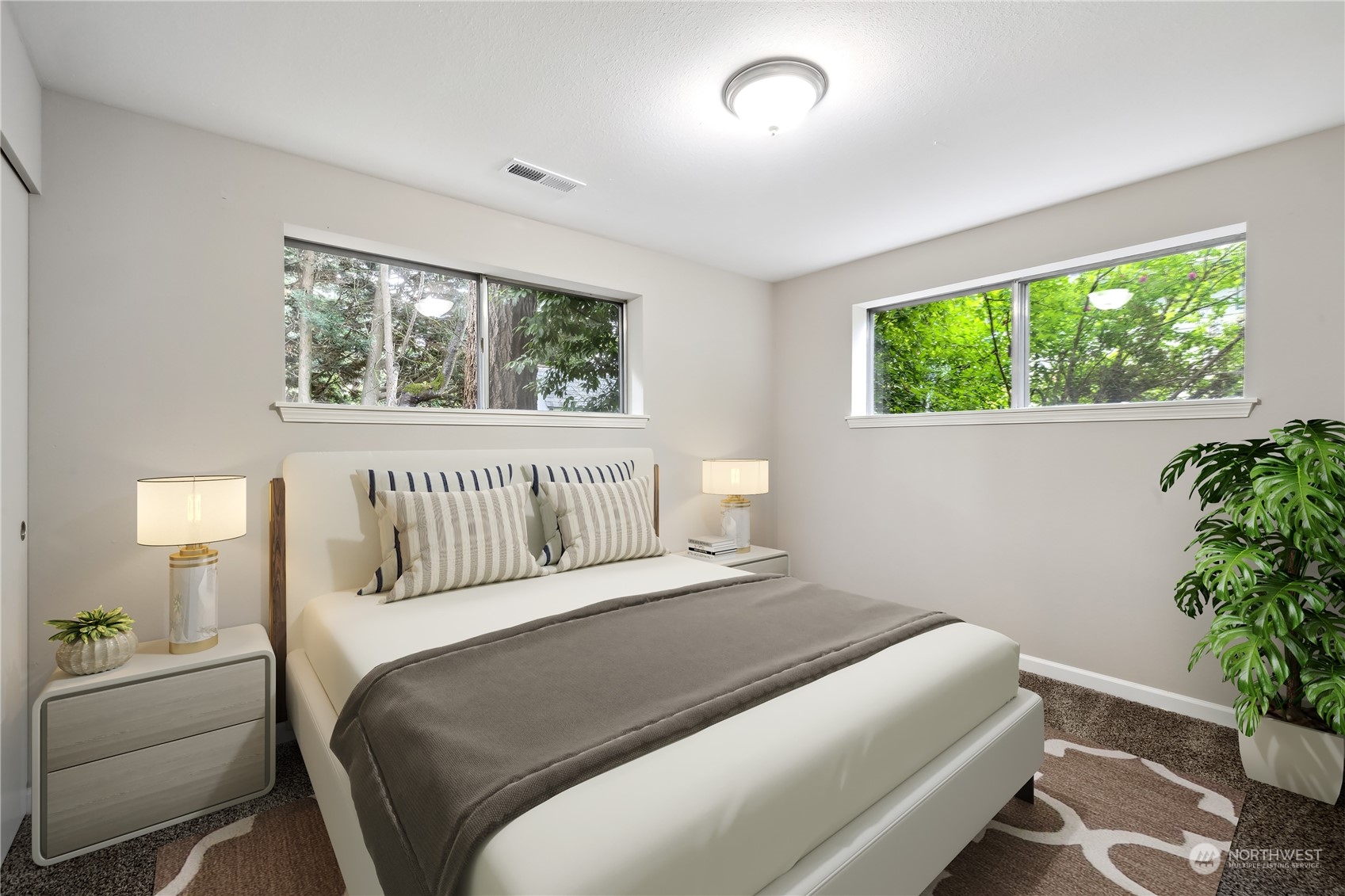 2130 242nd Street Southwest Bothell, WA 98021 - Photo 26 of 40 a bedroom with a large bed and a potted plant