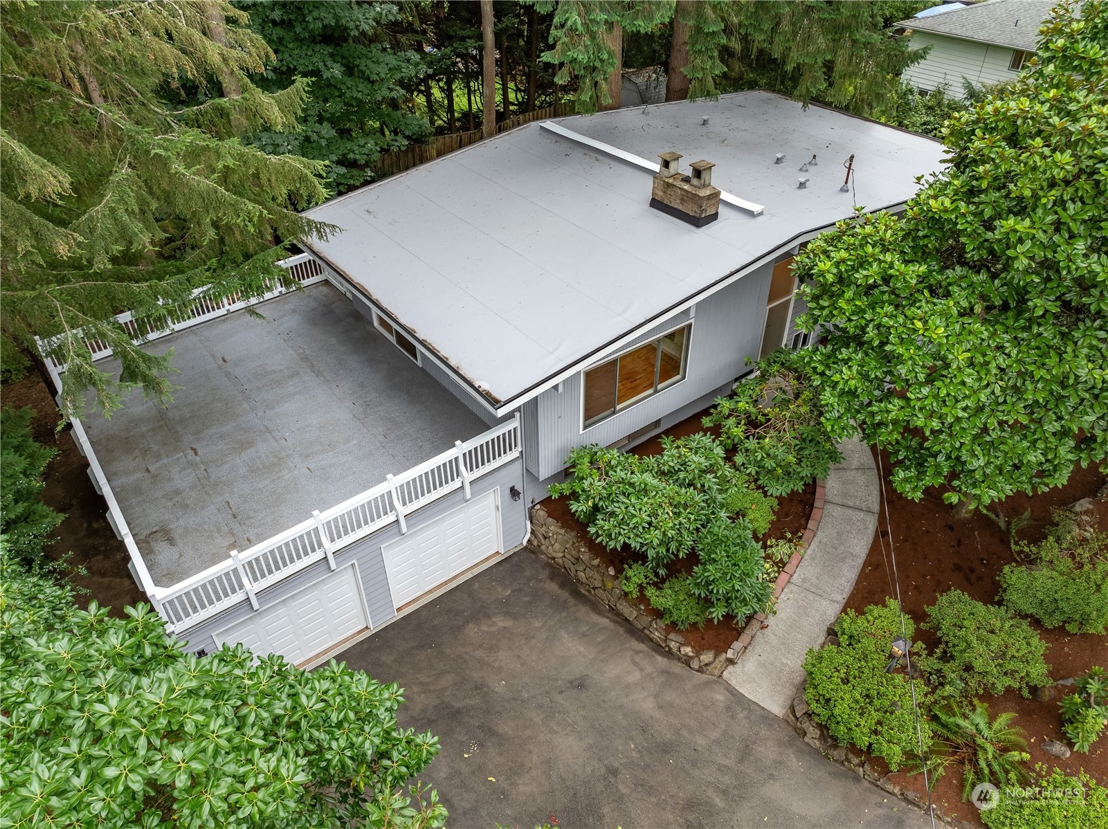 2130 242nd Street Southwest Bothell, WA 98021 - Photo 36 of 40 an aerial view of a house and yard with swimming pool and trees in the background