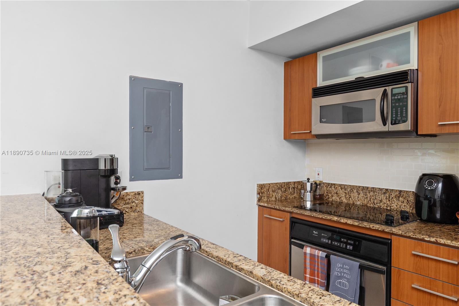 9055 Southwest 73rd Court, Unit 1603 Miami, FL 33156 - Photo 11 of 28 a kitchen with a stove microwave and sink