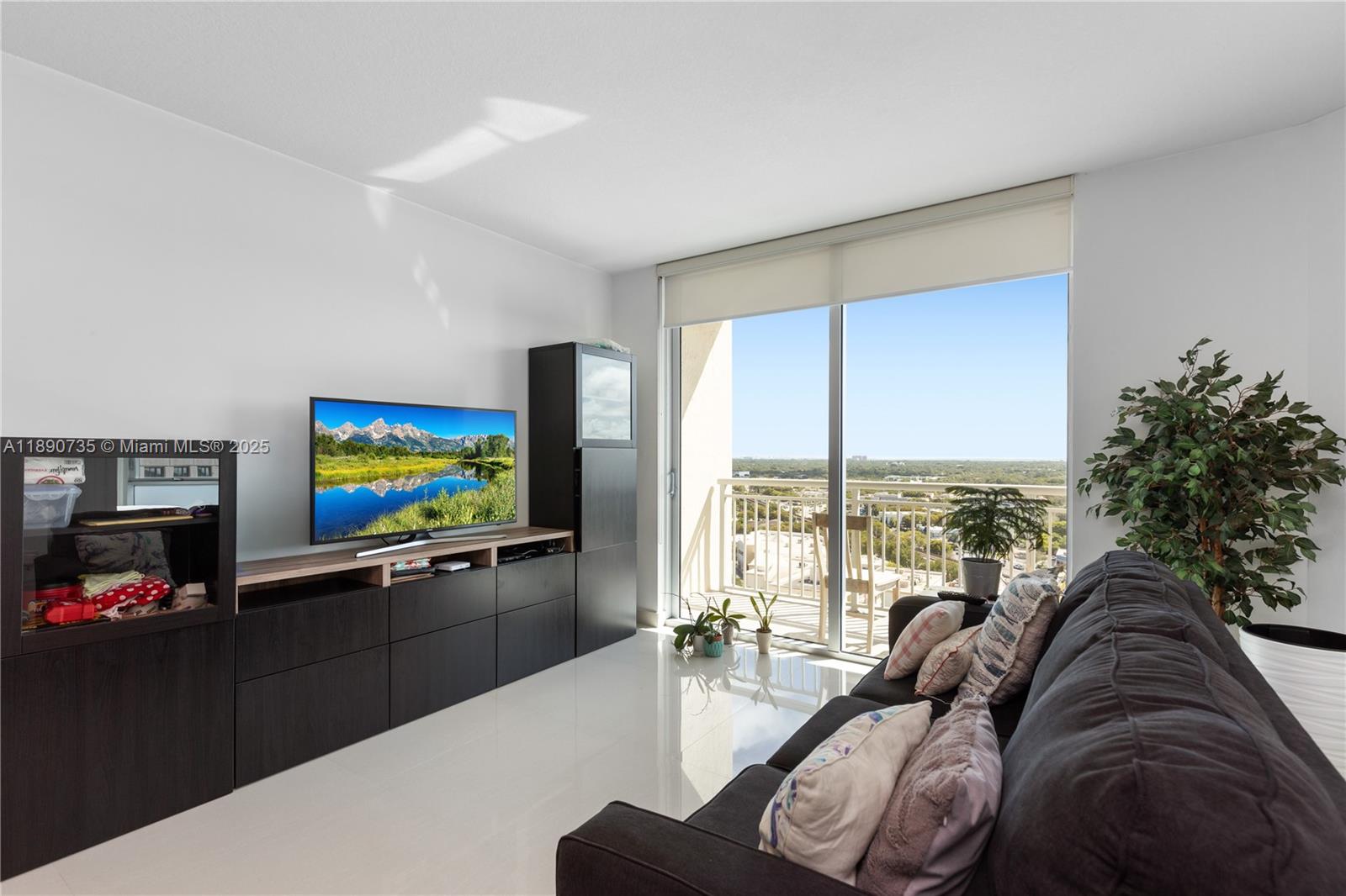 9055 Southwest 73rd Court, Unit 1603 Miami, FL 33156 - Photo 2 of 28 a living room with furniture and a flat screen tv