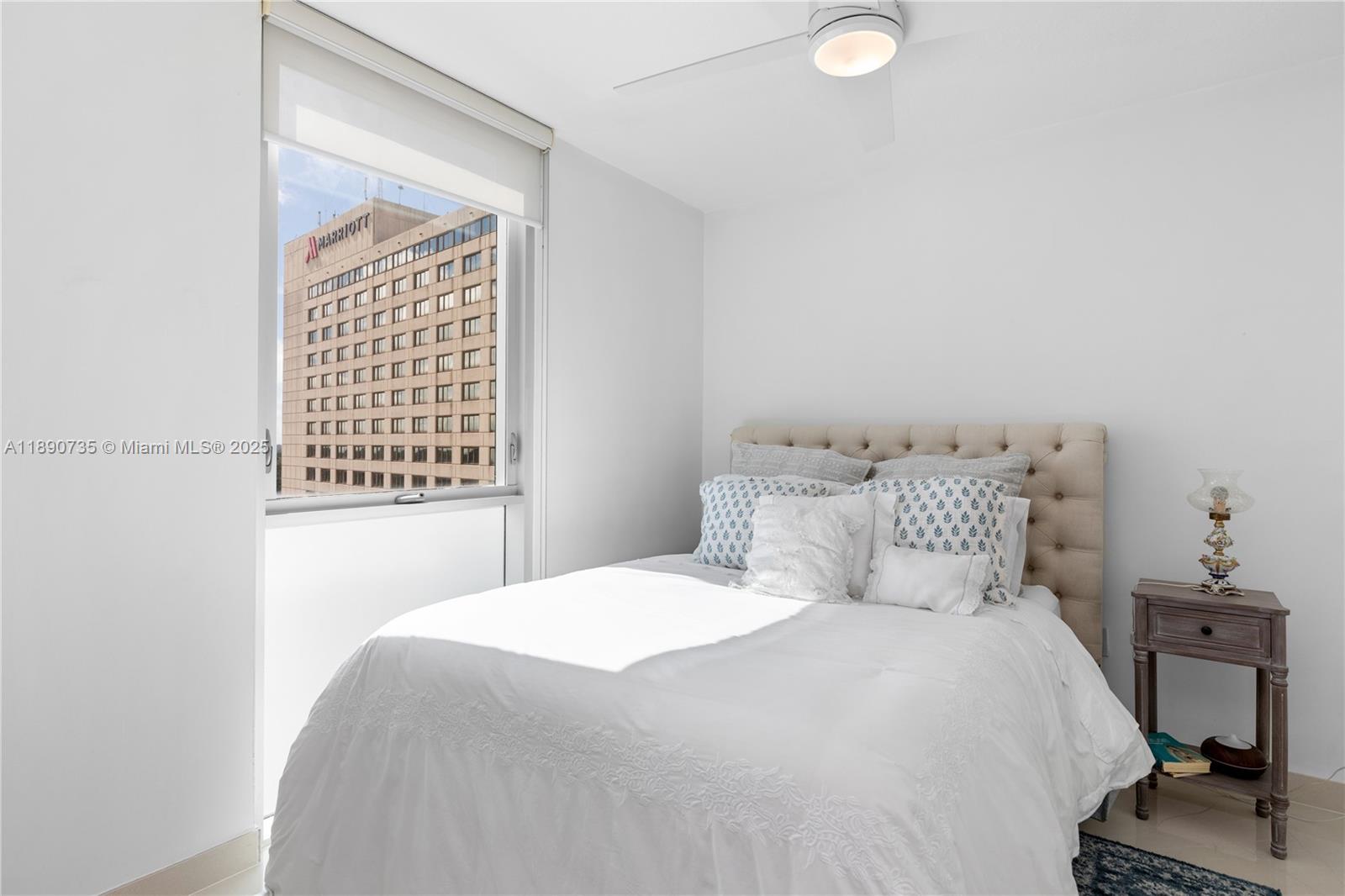 9055 Southwest 73rd Court, Unit 1603 Miami, FL 33156 - Photo 5 of 28 a bedroom with a bed and a window