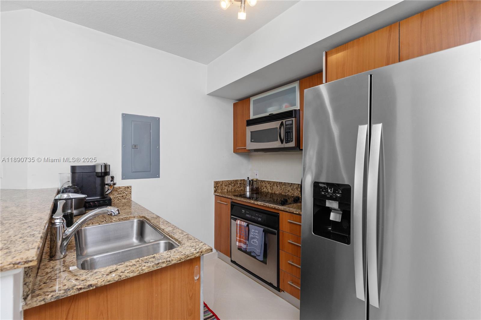 9055 Southwest 73rd Court, Unit 1603 Miami, FL 33156 - Photo 10 of 28 a kitchen with stainless steel appliances granite countertop a refrigerator stove and sink