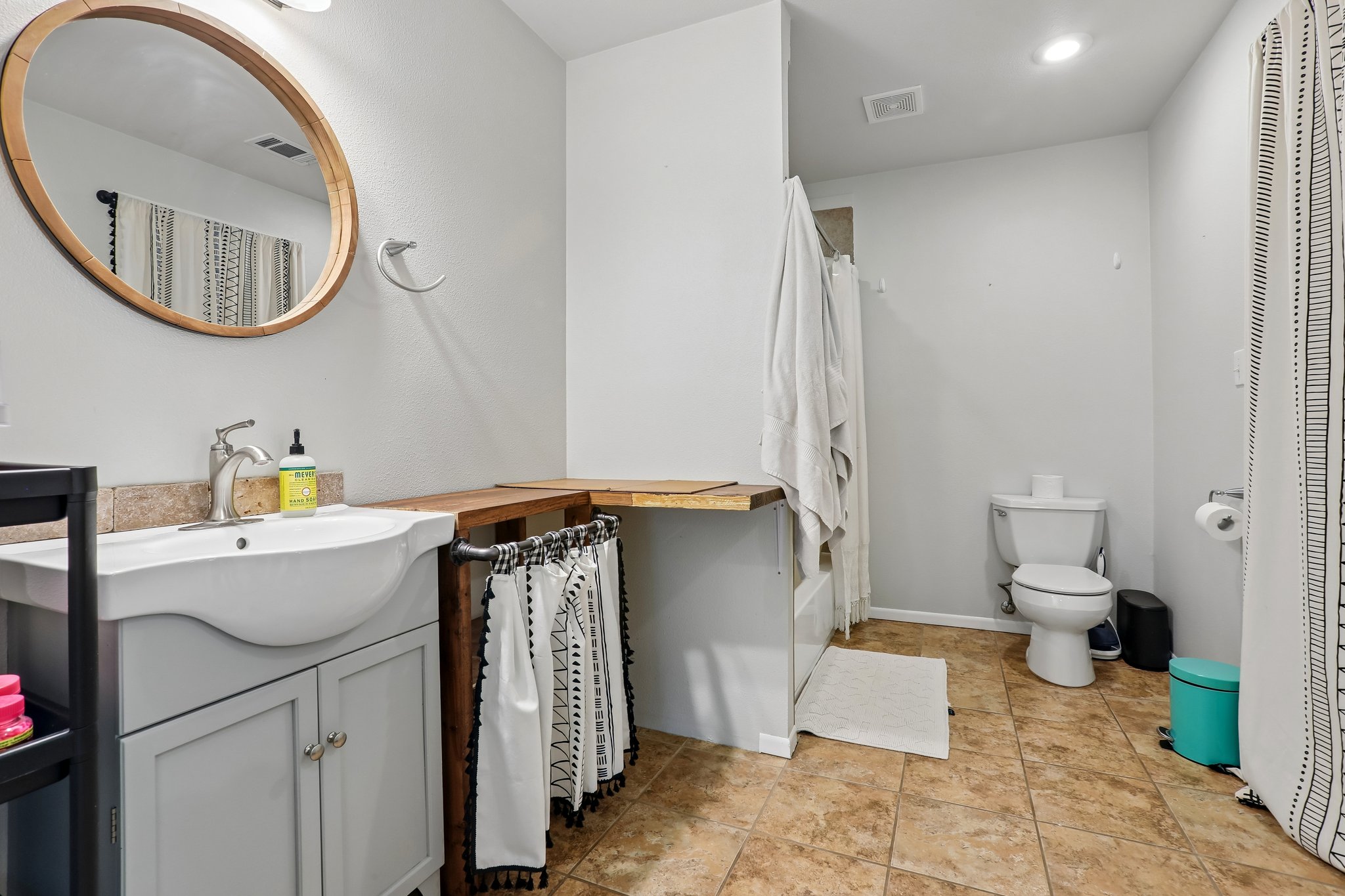 1114 West 2nd Street Elgin, TX 78621 - Photo 17 of 31 A well-appointed bath features a sleek vanity, mirror, and tiled flooring.