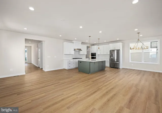 a kitchen with stainless steel appliances a stove and a refrigerator
