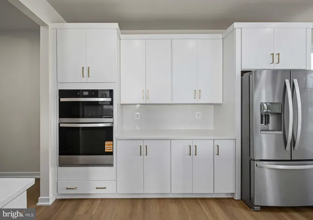 a view of a kitchen counter space a sink and appliances