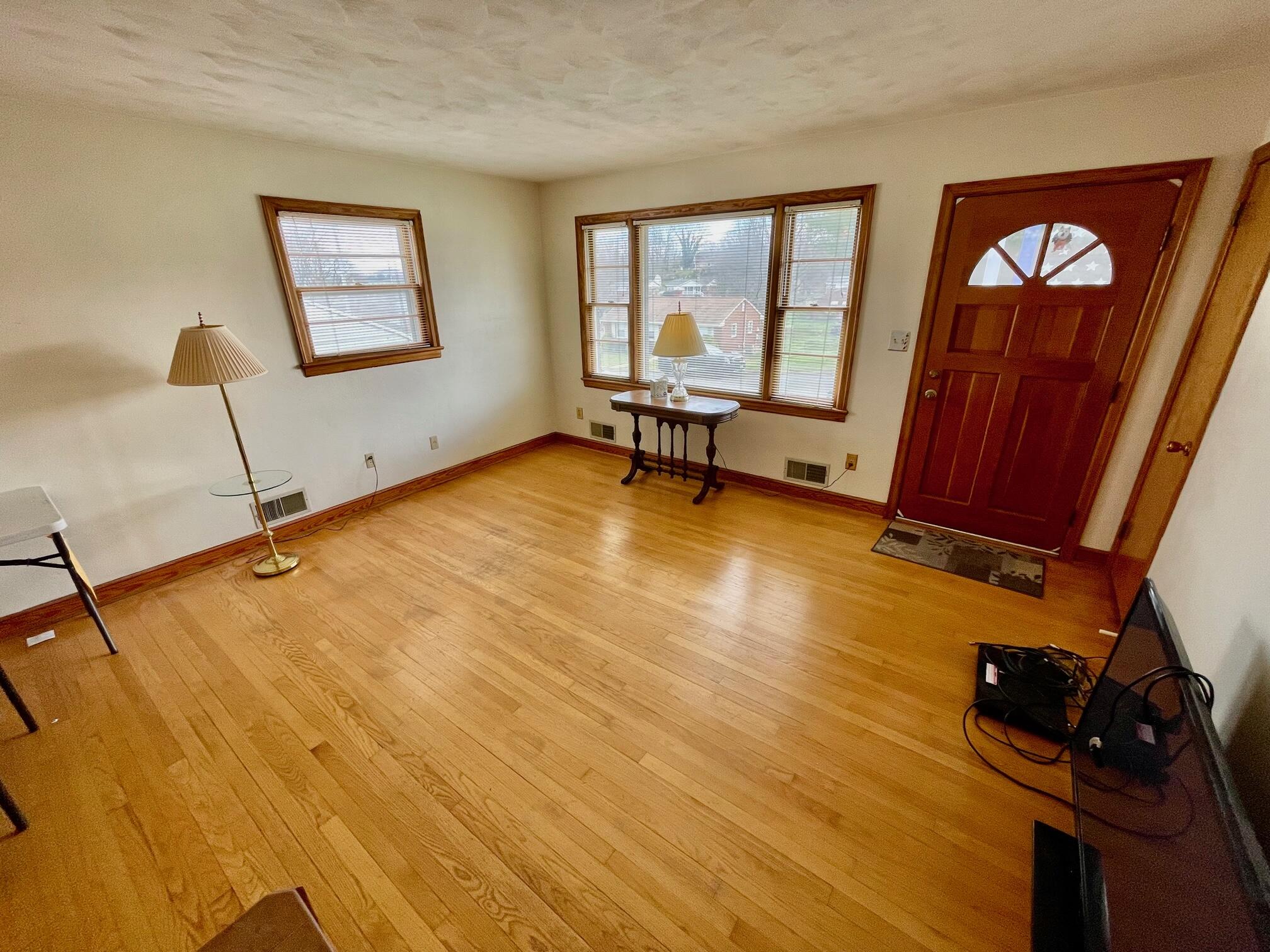 516 Mapleton Avenue Northeast Roanoke, VA 24012 - Photo 11 of 21 a view of an empty room with window and wooden floor
