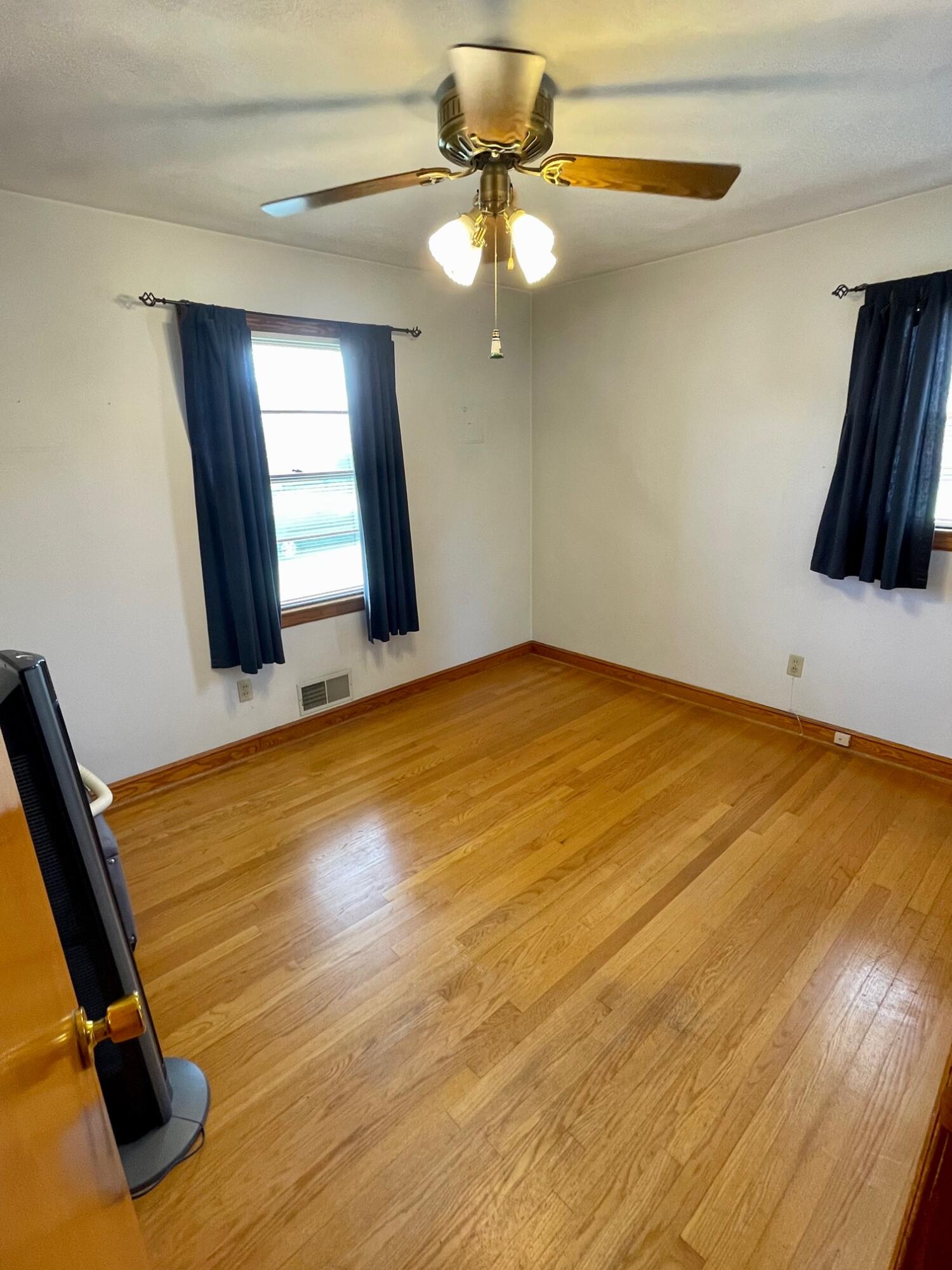 516 Mapleton Avenue Northeast Roanoke, VA 24012 - Photo 16 of 21 a view of a room with wooden floor and fan