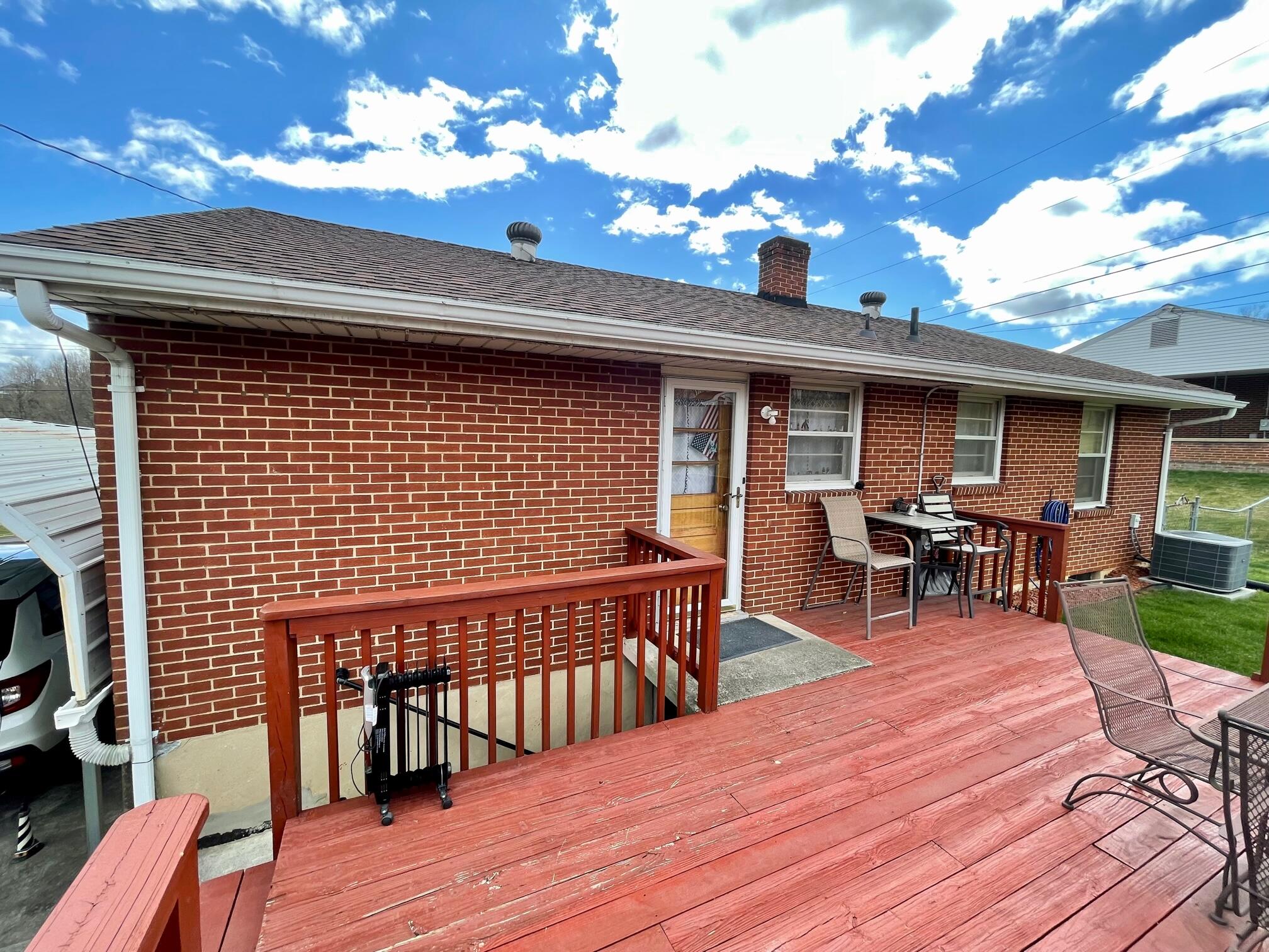 516 Mapleton Avenue Northeast Roanoke, VA 24012 - Photo 7 of 21 a view of a patio with table and chairs with wooden floor and fence
