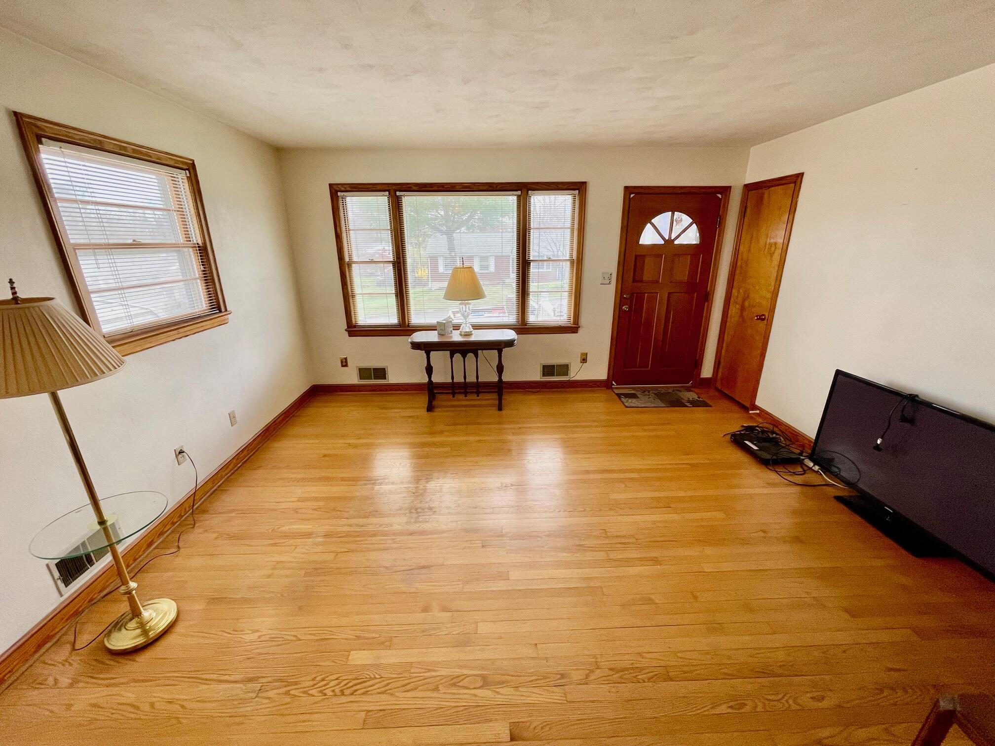 516 Mapleton Avenue Northeast Roanoke, VA 24012 - Photo 10 of 21 a view of an empty room with a fireplace and a potted plant