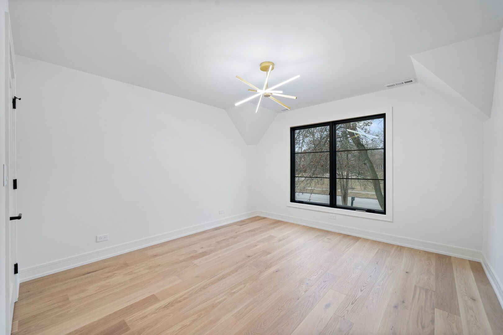 5603 South Garfield Street Hinsdale, IL 60521 - Photo 44 of 67 an empty room with windows and chandelier fan