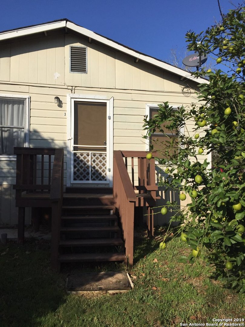a view of a house with backyard and sitting area