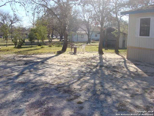 23717 Wood Park, Unit 3 San Antonio, TX 78264 - Photo 14 of 18 a view of a yard with yellow house