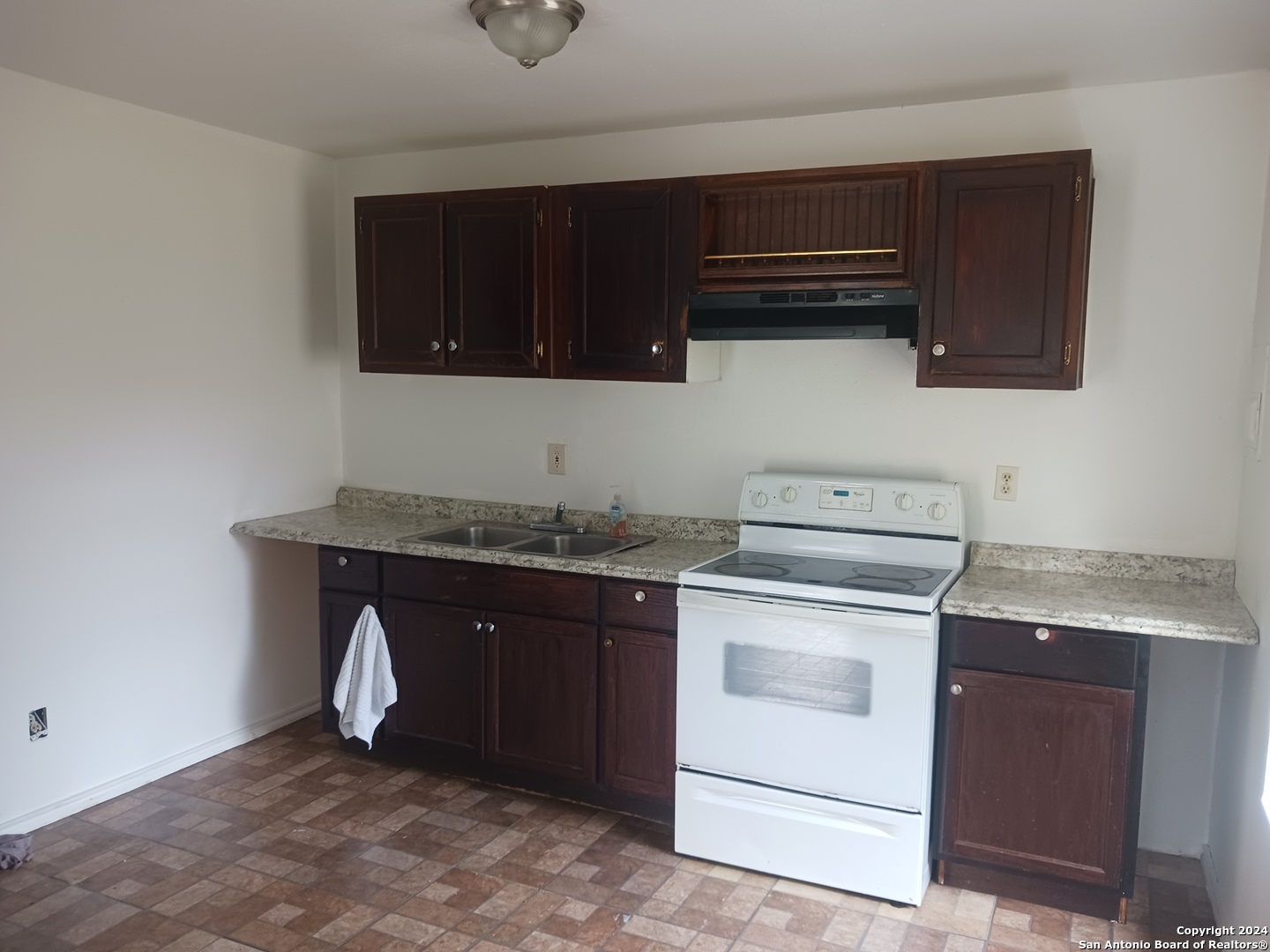 23717 Wood Park, Unit 3 San Antonio, TX 78264 - Photo 3 of 18 a kitchen with granite countertop stove top oven microwave and cabinets