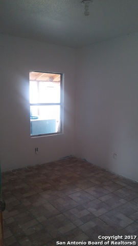 23717 Wood Park, Unit 3 San Antonio, TX 78264 - Photo 6 of 18 an empty room with wooden floor and windows