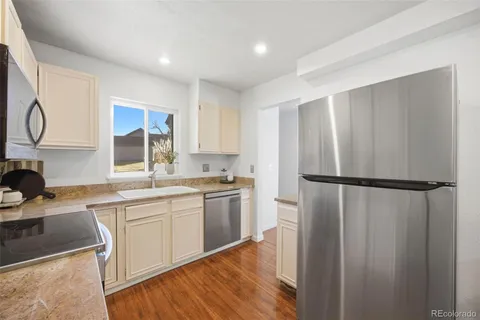 a kitchen with a refrigerator a sink and cabinets