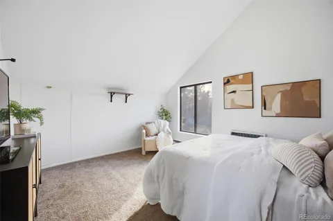 a bedroom with a bed and a potted plant