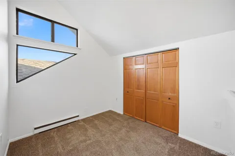 an empty room with closet area