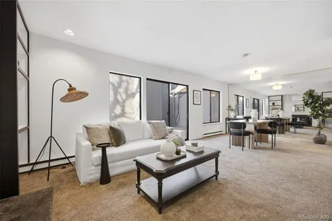 a living room with furniture and a floor to ceiling window