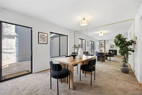 a view of a dining room with furniture and a potted plant