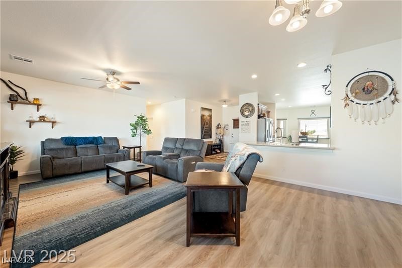 760 Fort Churchill Road Pahrump, NV 89060 - Photo 11 of 33 Living room featuring recessed lighting, light wood-style floors, and a chandelier