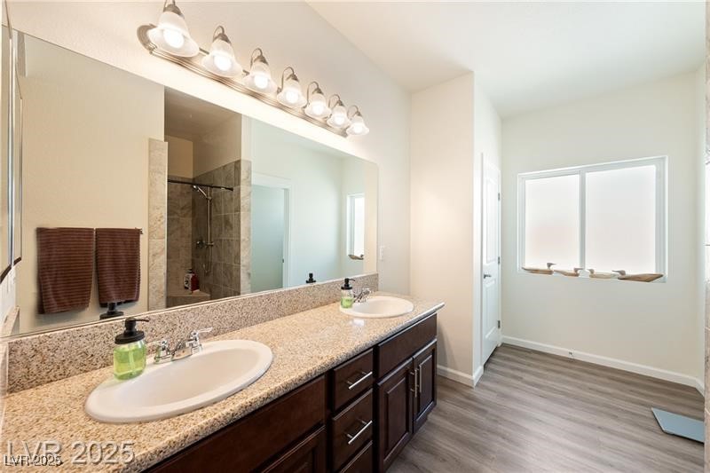 760 Fort Churchill Road Pahrump, NV 89060 - Photo 15 of 33 Full bathroom featuring double vanity, a stall shower, and dark wood-type flooring