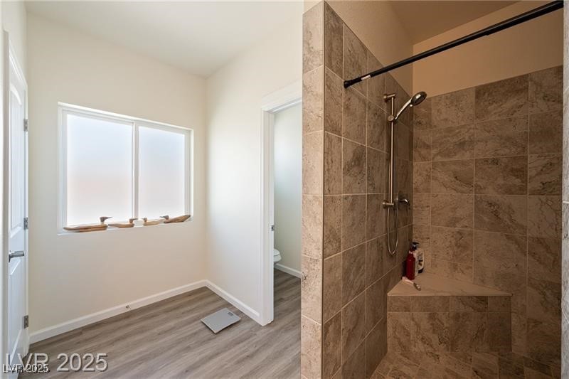 760 Fort Churchill Road Pahrump, NV 89060 - Photo 16 of 33 Bathroom with a tile shower and wood finished floors