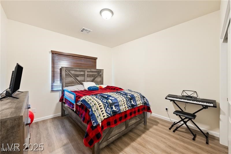 760 Fort Churchill Road Pahrump, NV 89060 - Photo 18 of 33 Bedroom with light wood finished floors and baseboards