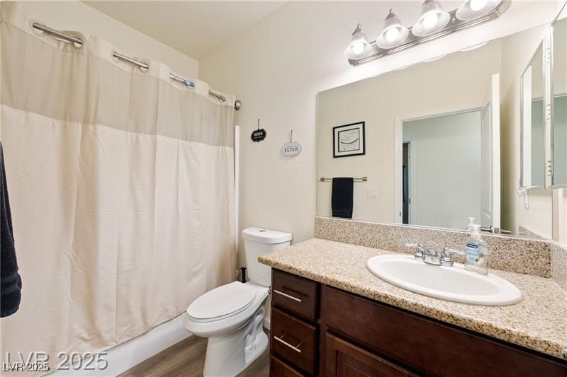 760 Fort Churchill Road Pahrump, NV 89060 - Photo 19 of 33 Full bath featuring vanity, shower / tub combo with curtain, and dark wood-style floors