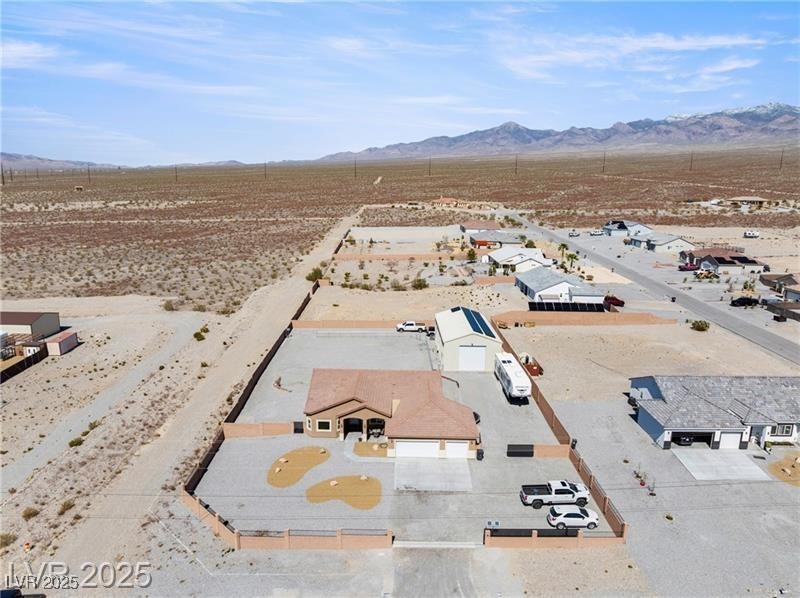 760 Fort Churchill Road Pahrump, NV 89060 - Photo 4 of 33 Aerial view of residential area with a mountainous background and a desert landscape