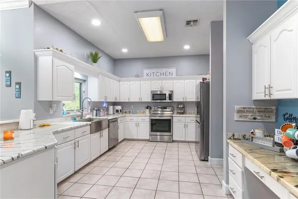 a kitchen with stainless steel appliances a stove a microwave and cabinets