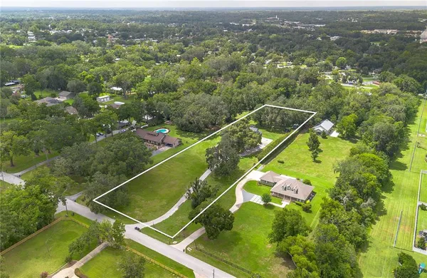 an aerial view of house with yard swimming pool and outdoor seating