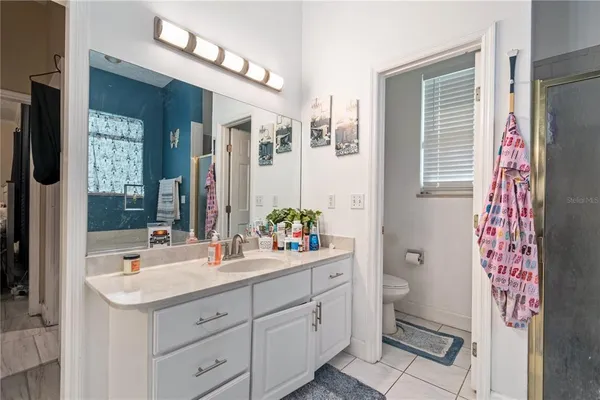 a view of a backyard with wooden fence and large trees