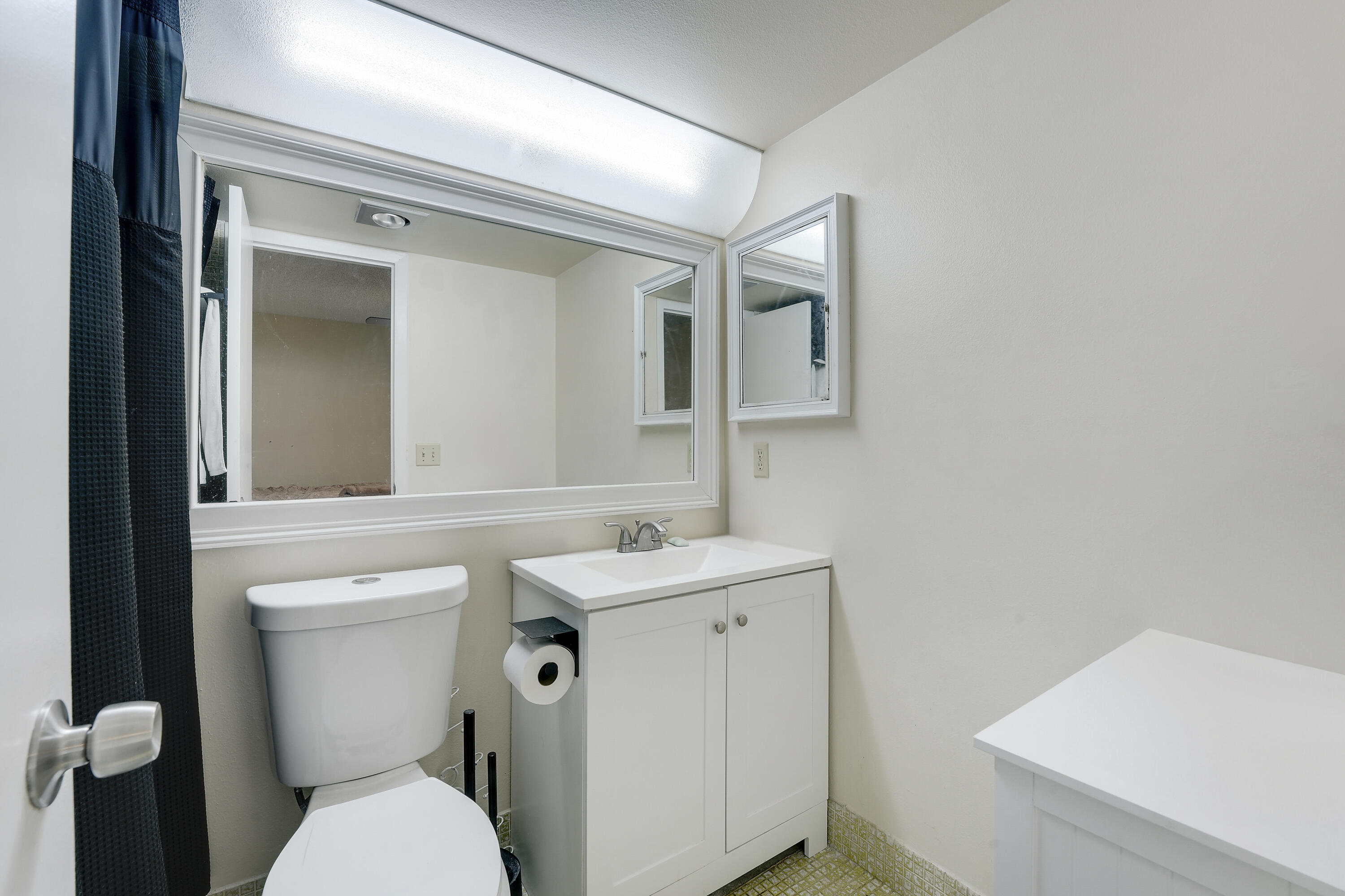 16 Mansfield B Boca Raton, FL 33434 - Photo 12 of 15 a bathroom with a toilet sink and mirror