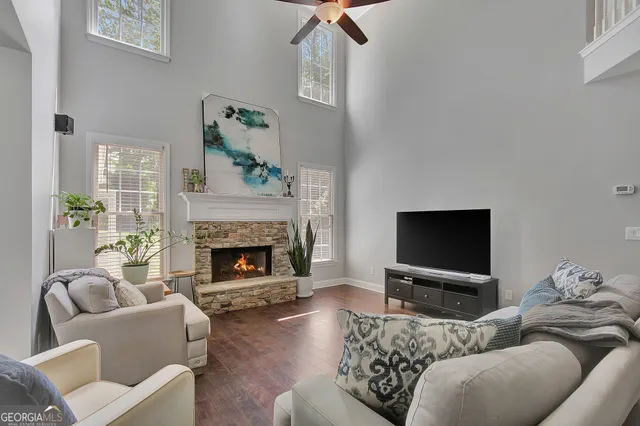a living room with furniture and a book shelf