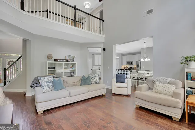 a kitchen with kitchen island granite countertop a table chairs stove and white cabinets