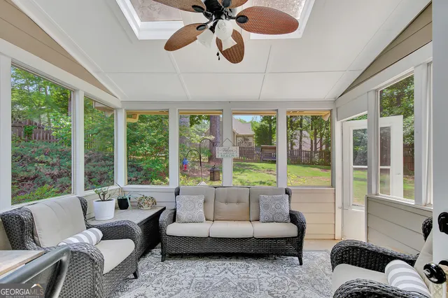 a living room with furniture a large window and a fireplace